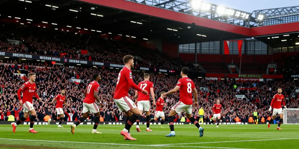 Exciting scene from the Manchester United vs Liverpool match highlighting intense rivalry and passionate fans.